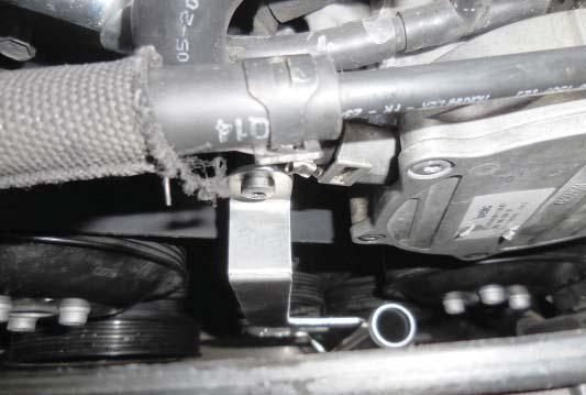 101. Install the bolt shown for the upper left hard line in the