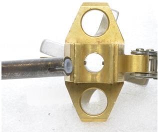 Figure 14: Insert the injector gadget. Figure 15: Align the gadget with the saddle pin. Rotate the brass knurled knob clockwise to tighten the injection gadget to the saddle.