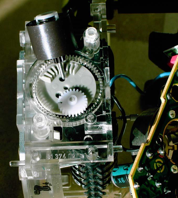 The rotor of the stepping motor has been removed and is shown above the gears. When assembled properly the rotor fits in the smaller central hole. Pic. 2.