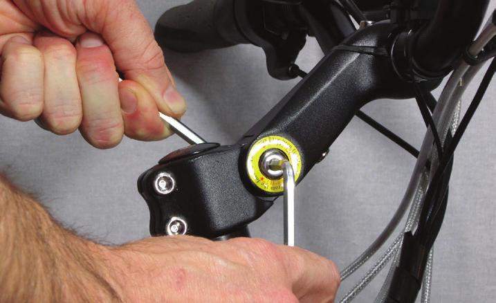 Re-tighten the two side bolts first, ensuring they are tightened very well. Finish by re-tightening the first bolt located under the handlebars (the one indicated by the arrow in Fig. 10).