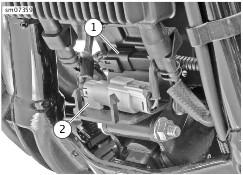 See Figure 23. Open front electrical caddy cover and disconnect front O2 sensor connector (2). Remove connector housing from caddy. 1. CKP Connector. 2. Front O2 Connector and Harness. 6.