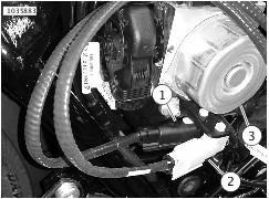 With the ATM inside the battery box, route grey and black connector harnesses: a. Start at front right corner of battery box area. b. Slide grey or black connector harness (1) between the brake lines (2) and frame rail (3).