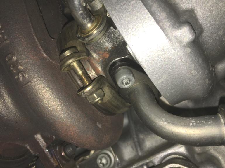 Remove the two bolts holding the oil drain line to the bottom of the turbo (see Figure 18).
