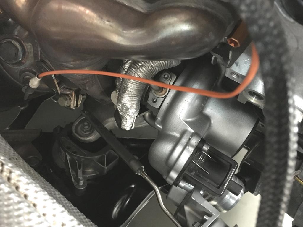 With the turbo pulled forward and rotated, you can access the oil line on top of the turbo. Remove the single bolt and pull the line up out of the turbo. Leave the line in the car.
