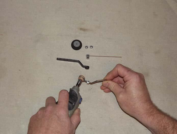 28. Disassemble the tailwheel assembly and use a rotary tool or a small file to create a flat spot on the tailwheel wire for the set screws in the aluminum cap to seat against.
