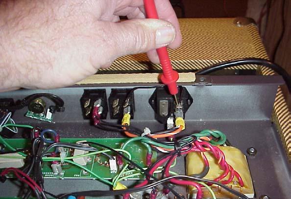 First we want to measure the line voltage coming into the amp. With the red test lead probe touch it to the wire shown in the photo below and record the reading on the bias calculation worksheet.