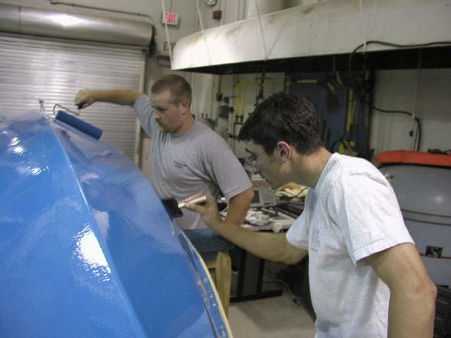 Tim and Mark apply a second coat of finish in the same manner.