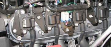 Disconnect the two ignition harness connectors, the eight spark plug wires from the ignition coils and