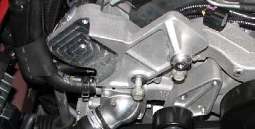 Use a 15mm socket to remove the nut retaining the ground strap on the passenger side cylinder head then use a 15mm deep