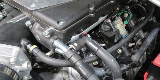 Use a small flat blade screwdriver to remove the wire loom covers from the back of the ignition coil brackets. 124.