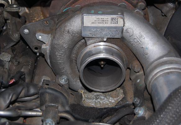 This shot shows the turbo with the TA removed. Observe the position of the 3 bolts. You can also see the 4th bolt that you do not have to remove.