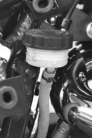 Rear Brake Fluid Level 1. Remove the right side cover. 2. Straddle the motorcycle and bring it to the fully upright position. 3. View the brake fluid through the reservoir. The fluid should be clear.