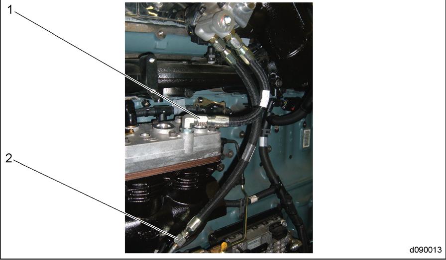 5. Disconnect the coolant supply hose for the EGR heater plate at the air compressor. See Figure 2. 1. Coolant Supply Hose to Air Compressor 2.