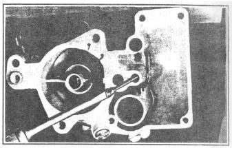 gasket. FIGURE 12 5. Remove the metering rod jet and gasket assembly, Figure 12.