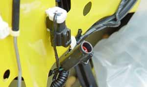 The hole that is exposed just to the rear of the vertical lock linkage is used to access the 10mm screw that secures the
