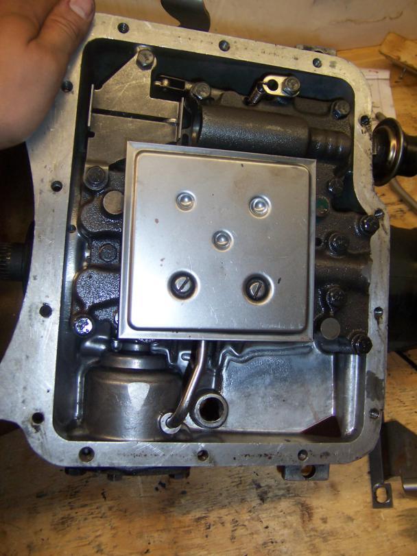 Then place the bolt through the retainer plate and tighten to specifications.