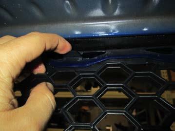 Remove the lower grille from the vehicle.