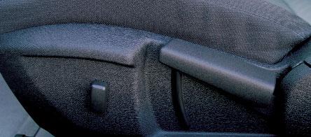 The manual front seats may be moved forward using the handle under the front of each seat.