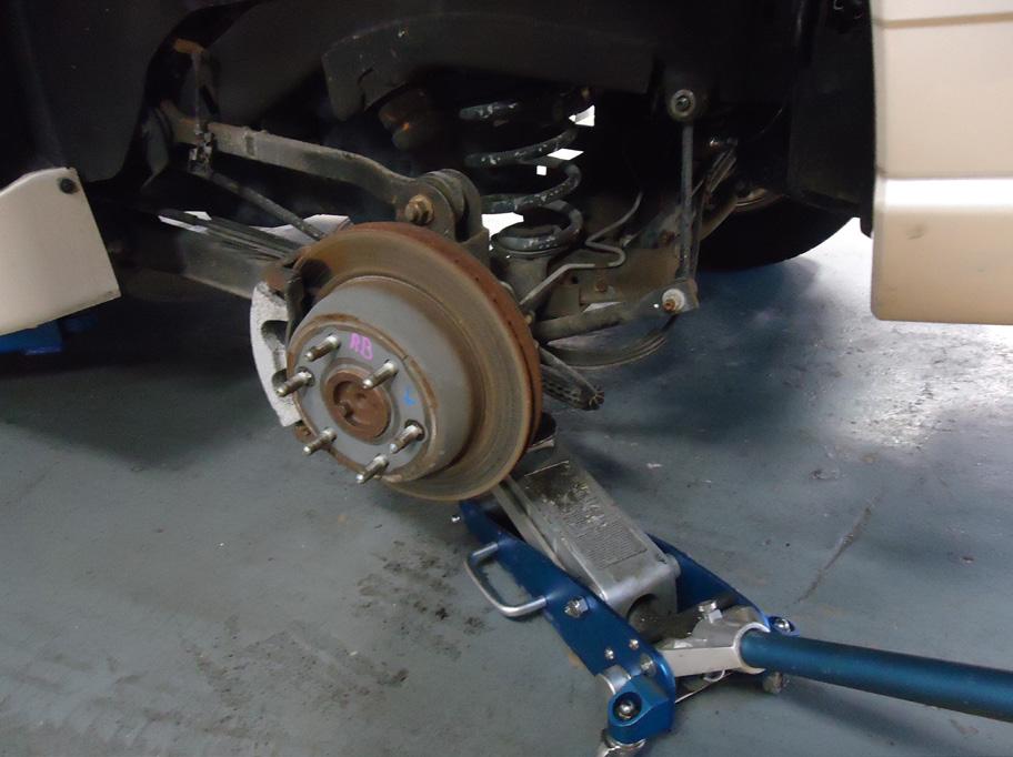 10. USING A JACK OR OTHER SUITABLE DEVICE, SUPPORT THE AXLE TO RELEASE PRESSURE FROM THE SWAY BAR