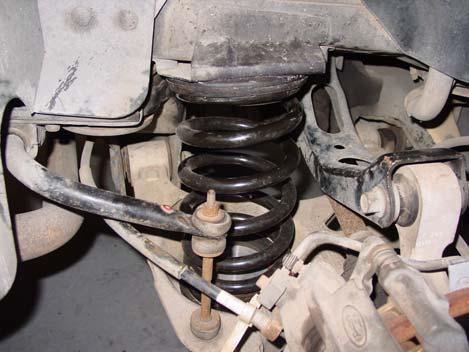 16. Place the floor jack under the lower control arm so you can compress the coil spring. 17. Bolt stabilizer bar link back to the lower control arm. (Refer to step 9) 18.