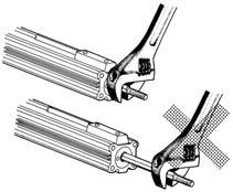 onto the threaded section at the end of the piston rod, return the piston rod to its fully retracted position, and grasp the exposed portion of the rod across two parallel sides with a wrench.