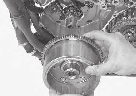Wipe any oil off the mating surface of the flywheel with crankshaft. Install the flywheel to the crankshaft, aligning its key groove with the woodruff key.