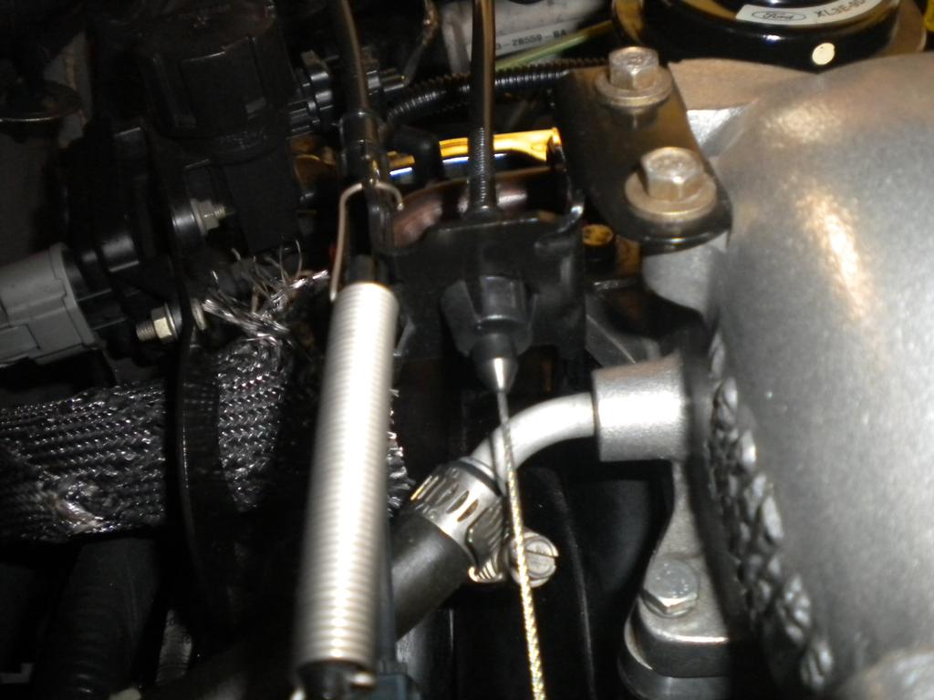 6. Disconnect the cruise control linkage from the throttle body by lifting up on it.