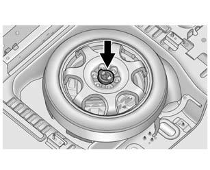 10-74 Vehicle Care 5. Remove the nut retaining the spare tire. 6. Remove the spare tire and place it next to the tire being changed. 7. Remove the wing nut. 8.