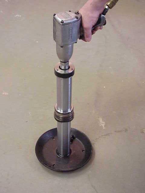 STEP 7 - BY UTILIZING A PNEUMATIC IMPACT WRENCH, BREAK THE ROD BOLT FREE OF THE LOCKTITE