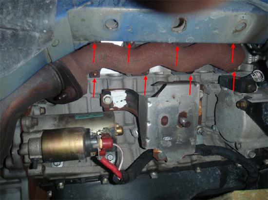 23. Now you re ready to remove the stock manifolds. Using a 13mm deep socket and various extensions, you can remove all the nuts holding the manifolds in place.