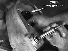 Remove the yoke and rear-output shaft spacer from the rear output shaft. See Fig. 12. 14.