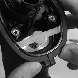 Starting at the top, work the housing ring down on the facepiece to capture the facepiece rubber in the ring groove.