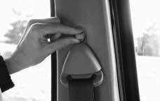 The belt should be away from your face and neck, but not falling off your shoulder. To unlatch the belt, just push the button on the buckle. The belt should go back out of the way.