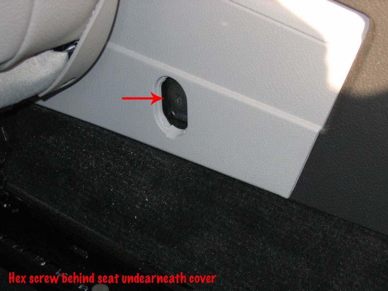 5 Remove the rear ash tray and insert the regular screwdriver between the black and grey plastic piece and pull up.