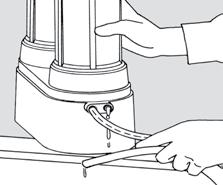 Slide the small wrench around the outlet tubing or spout elbow, with the indented side of the wrench facing the unit, and while pushing in
