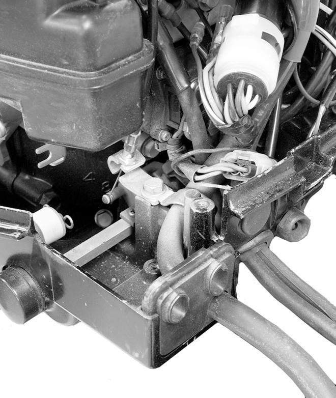 ENGINE INSTALLATION 2. Route the remote wiring harness through the rubber grommet. 3. Open up the clamp in the bottom cowl and position the remote wiring harness below the clamp.