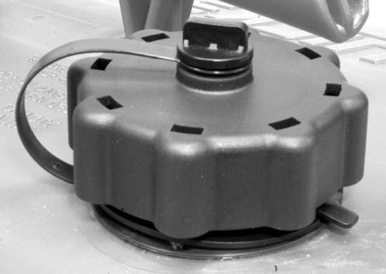 FUEL AND OIL REMOVING THE FUEL CAP a b a - Fuel cap b - Manual vent screw c - Tab lock IMPORTANT: Contents may be under pressure. Rotate the fuel cap 1/