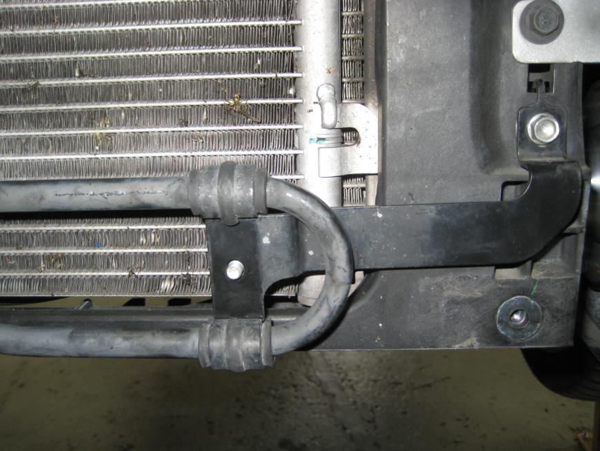 15. Undo the bolt holding the power steering cooler pipe to its bracket, then position the pipe BEHIND the bracket and bolt it up from the other side (this has the effect of pushing the power
