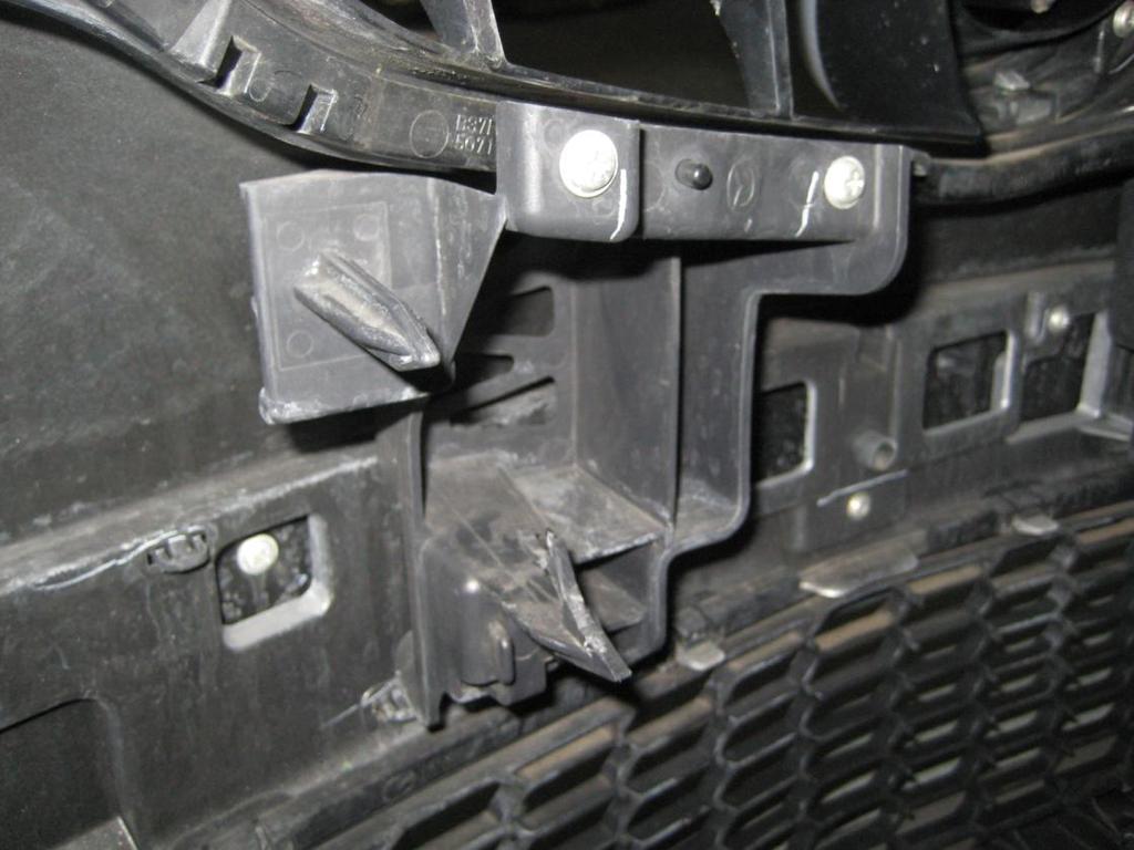 Reach down behind the top grille either side of the bonnet latch, and you should see two black clips