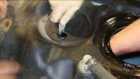 Install the grommet (P/N 5J-1-1-04-0001) in the new suction tube access hole as