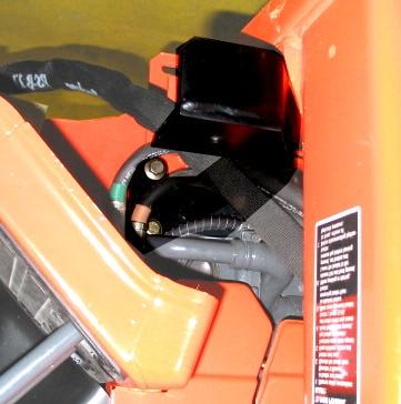 Figure 4 5. Repeat for the right front bracket. See Figure 4. Figure 5 behind the seat area. Remove the diptsick and hydraulic speed control knob.
