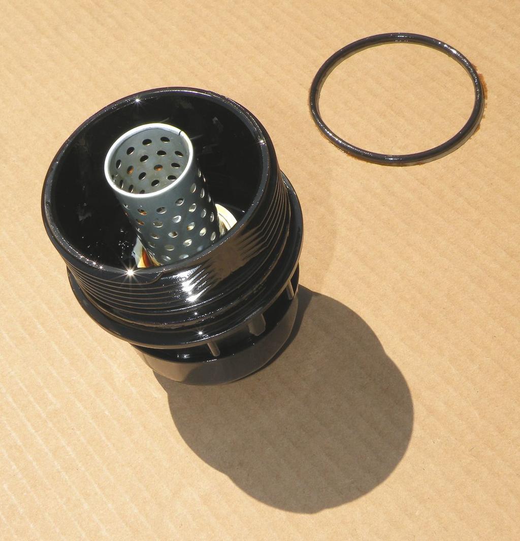 The old rubber O-Ring must be carefully removed at this point. It s located at the base of the filter-cap threading. Both are shown in the photo above (with the wrench still attached at the bottom).