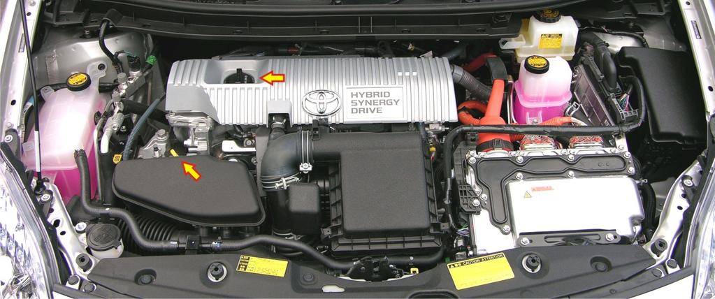 The black cap on the left side of the silver cosmetic cover over the engine is where the new oil is poured, indicated above by an arrow. (Also indicated is the dipstick location.