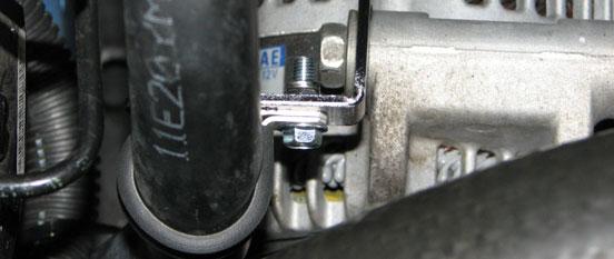 Route the grounding strap on the water pump harness over to the grounding stud on the passenger side strut tower.