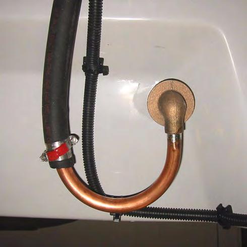 Loosen the two hose clamps and remove the hose from the vent fitting. Remove the clamps from the hose.