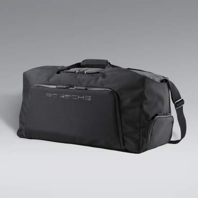 Detachable, adjustable shoulder strap with non-slip padding. Water-repellent outer zippers. Made of durable polyester/ nylon. Dimensions: 28.35 x 13 x 11.81 in. In black.