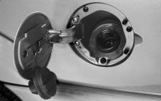 The fuel cap is behind a hinged door on driver s side of your vehicle.