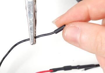 Slide a small 1" piece of heat shrink onto the black wire