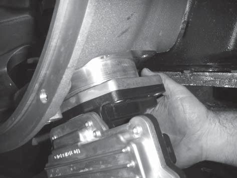 1. Install the ECA into the clutch housing bore. Align it with the lower cross-shaft. 3. If applicable, install the four (4) cap screws for the ECA shield. Tighten them to 35-45 lb-ft. (47-61 N m).