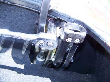 Remove the hydraulic line clips and place a rag under the lock assembly.